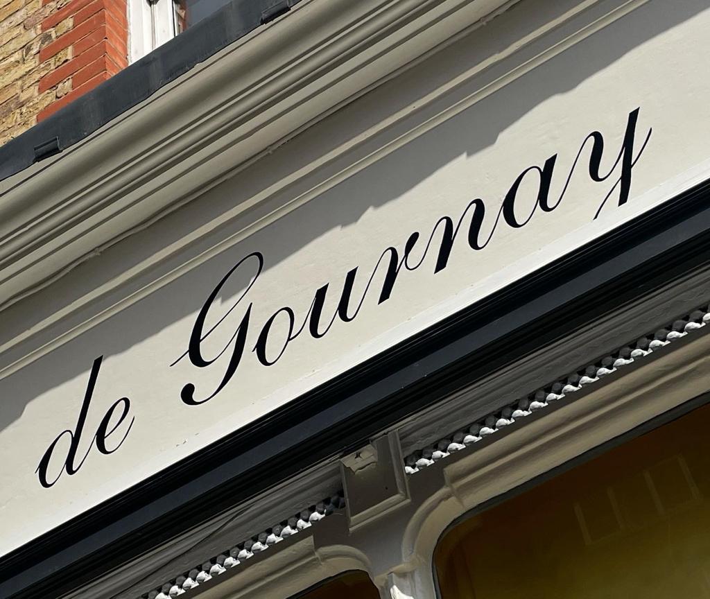 Seraina gilding lettering on glass at De Gournay Fulham London