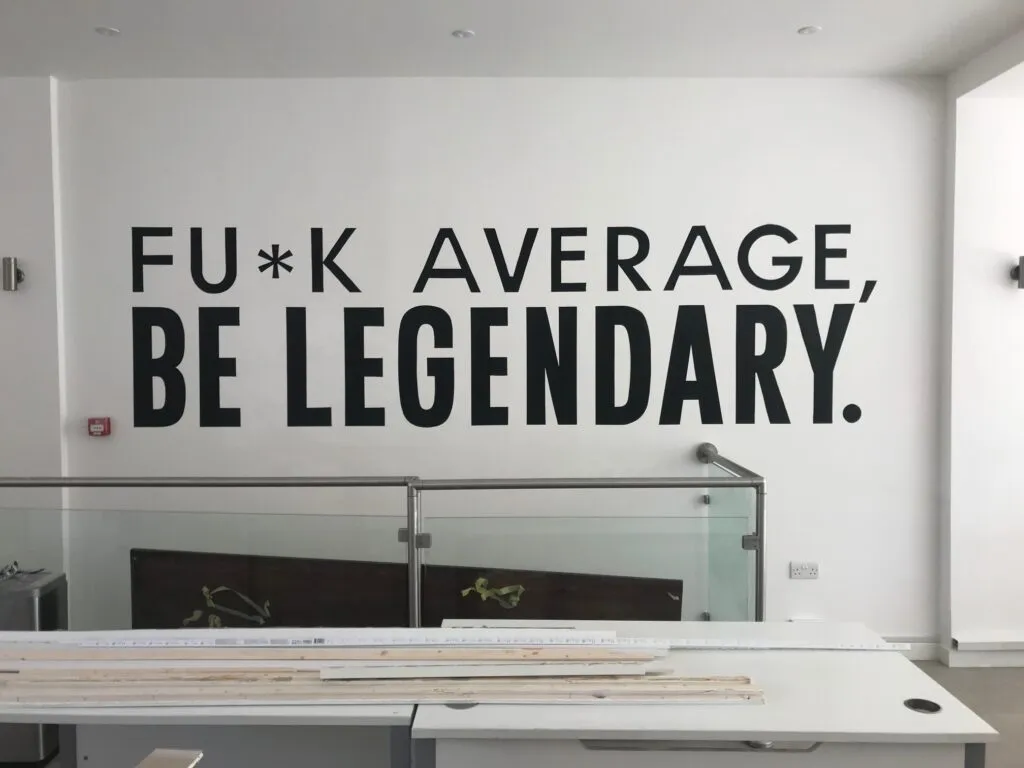 Company Logo Wall graphics, Media Office Signage painted by hand by Seraina & NGS. Gold Victorian House numbers by Seraina London sign writer, Vegan sign writing Woman, Girl sign writer, Gluten Free signs. Healthy house number design, vegan designer. Vegan sign writing Woman,