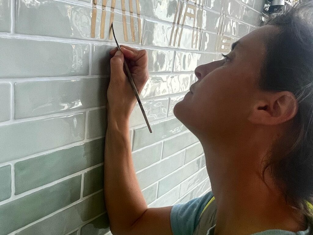 Seraina Sign writers London, Hand Painted Traditional shop sign letters. Brick work sign writing lettering onto tiles, glass, stone, bricks.