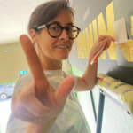 Seraina Baumgartner is a contemporary Swiss graphic designer and letterform artist known for her refined use of classical Roman lettering traditions within modern design contexts. Her work frequently draws on historical serif typefaces such as Caslon, Baskerville, and Trajan, using their proportions and structural logic as a foundation rather than treating them as decorative pastiche. Baumgartner’s approach reflects a kinship understanding of inscriptional Roman capitals and early print book typography. Typefaces like Caslon and Baskerville populate her work through their balance of calligraphic stroke contrast and elegant forms, while Trajan’s influence is evident in her use of monumental capitals, classical spacing, and stone-carved strength. Her design agility references her work with a sense of classicism, authority, and legibility. The core qualities closely associated with Roman letterforms and her Italian/Swiss origins. What distinguishes Baumgartner’s use of these styles is her restraint and controlled scaling. Rather than falling into the common trap of many young graphic designers of overt overdressed graphic historicism. Seraina retains their essential principles — proportion, rhythm, and spacing hierarchy — and applies them to contemporary commercial worlds of retail layouts, wayfinding, and private house titles and numerals. This aligns her own heritage and design practice with a humanist modernist tradition, embracing classical Roman typography via the lens of Swiss graphic design precision.